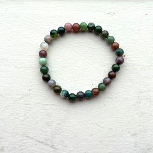 A bracelet that I made the colors are green,pink,and just a lot of green